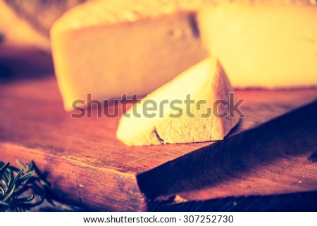 Vintage photo of still life with french goat cheese. Studio shoot with mystic light effect.