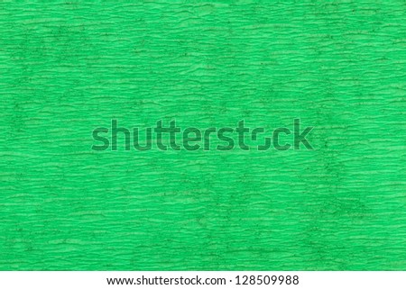 macro detail of green folded crepe paper in soft lighting