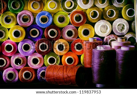 many colorful spools of thread for sewing, colorful background