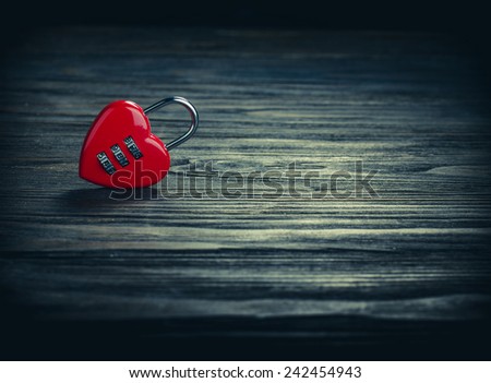Heart lock on old wood background, with vintage filter.Valentines Day background.