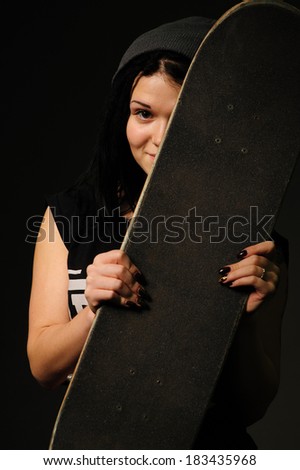 beautiful young woman holding a skateboard