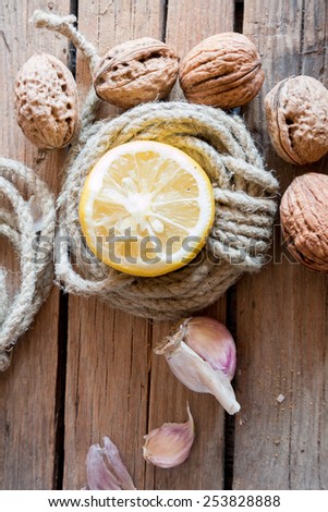 Food background, garlic, walnuts and lemon. Healthy food.