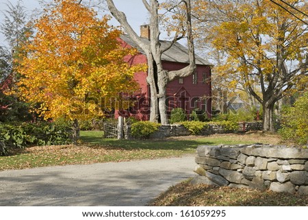 A beatiful red cottage in Connecticut countryside during foliage season, New Preston, USA