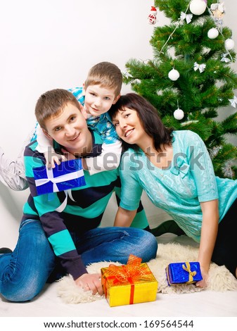 Young family having fun under the Christmas tree