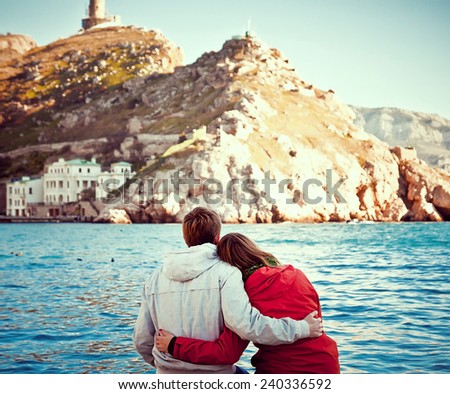 young couple sitting on the dock