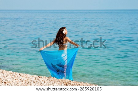 girl on the beach with a blue handkerchief