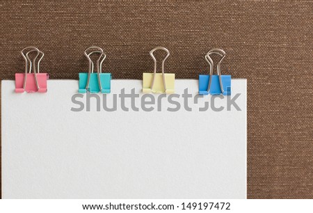 White paper note with  colorful paper clips