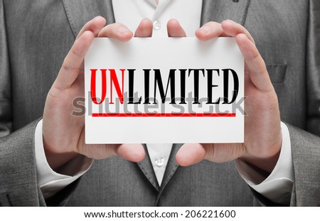 Unlimited written on a card in businessman\'s hands