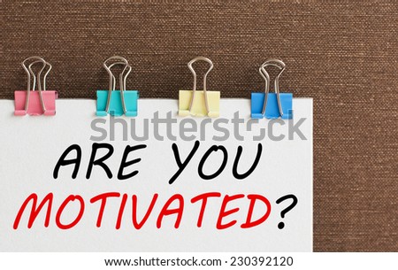 Are You Motivated ? written on a white note paper with colorful  clips