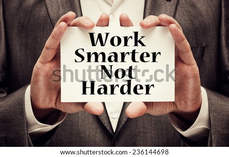 Work Smarter Not Harder Concept. Man holding a card with a motivational message text written on it