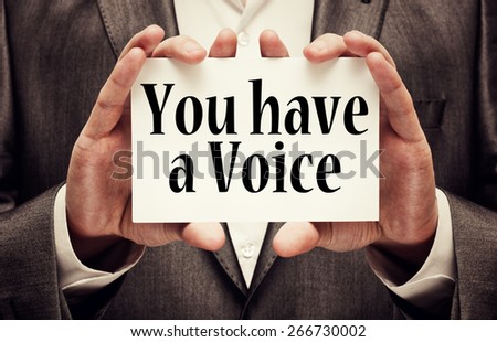 You Have a Voice. Businessman holding a card in hands