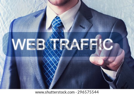 Businessman touching Web Traffic button on virtual screen