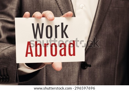 Work Abroad card in male hand