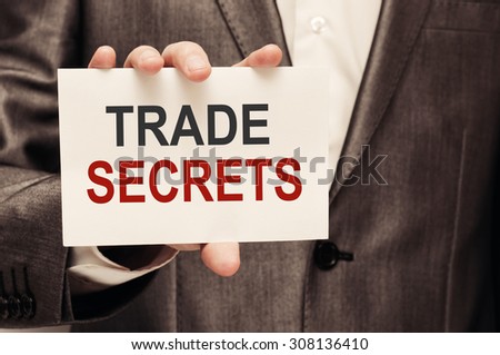 Trade Secrets Concept. Man holding a card with a message text written on it