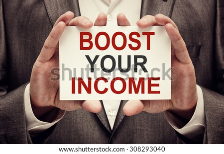 Boost Your Income. Man holding a card with a message text written on it