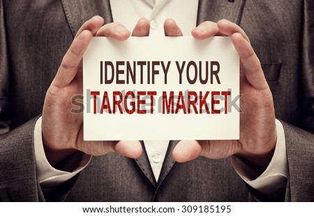 Identify Your Target Market. Man holding a card with a message text written on it