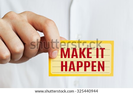 Make It Happen. Businessman holding a card with a message text written on it