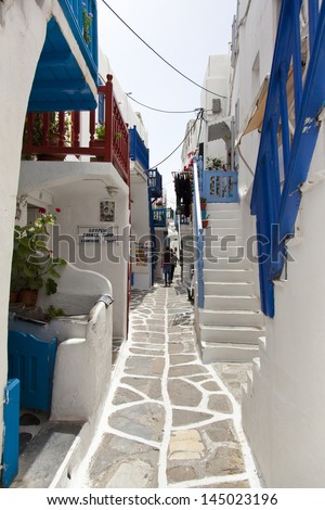 MYKONOS, GREECE- MAY 16: Mykonos street with external colourful stairs of the houses and restaurants,  Mykonos, Greece, on May 16, 2013.