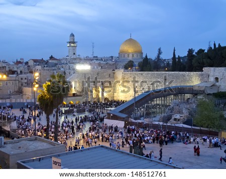 JERUSALEM - MARCH 30: Passover Holiday. People are going to Western Wall for praying, at the same time Muslims are praying on Dome of Rock. March 30, 2013 in Jerusalem, Israel.