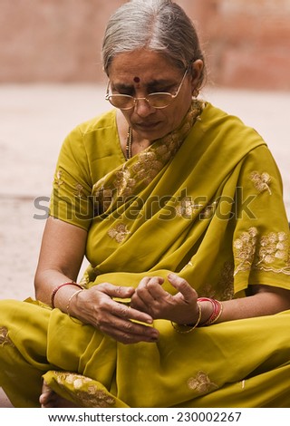 RAJASTHAN, INDIA- 17 November 2010: An old Rajasthani lady siting on street with her traditional clothes, Rajasthan, India