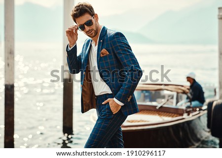 Similar – Image, Stock Photo Stylish man in suit walking on pavement with electric bike