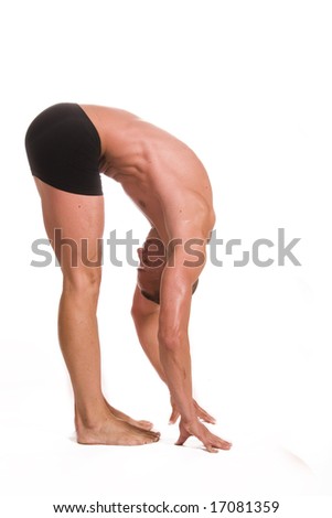 young sportsman stretching on the white background