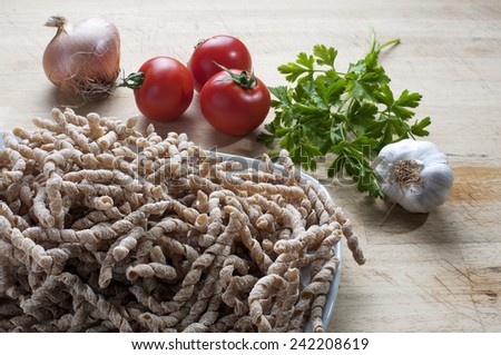corkscrew shaped raw pasta called busiate with whole wheat flour  of buckwheat typical of Sicily