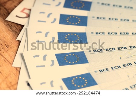 spending review concept with european bills on a wooden board white tone color