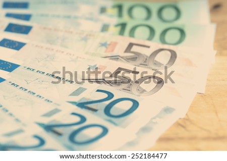 spending review concept with european bills on a wooden board