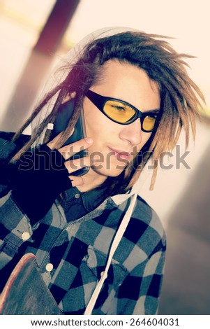 portrait of young guy  with rasta hair in a lifestyle concept warm filter applied