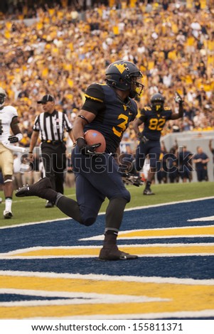 MORGANTOWN,WV - AUGUST 31, 2013:William & Mary at WVU. Charles Sims breaks into the end zone for his first touchdown.