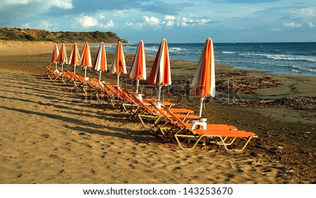 Orange sea chairs at an empty beach, Kefalonia, Greece