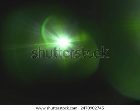 The​ black​ back​ground​ image​ has​ a​ white​ and​ green​ beam​ of​ light​ shining​ through​ it​ for​ Graphics​