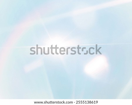 The​ light​ blue​ back​ground​ image​ has​ a​ white​ and​ rainbow​ beam​ of​ light​ shining​ through​ it​ for​ Graphics​
