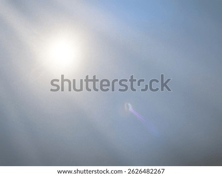 The​ gray​ back​ground​ image​ has​ a​ white​ and​ purple​ beam​ of​ light​ shining​ through​ it​ for​ Graphics​