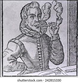 16th century Dutchman smoking a long-stemmed pipe, with another pipe and roll of tobacco on the table. 1595 wood engraving.