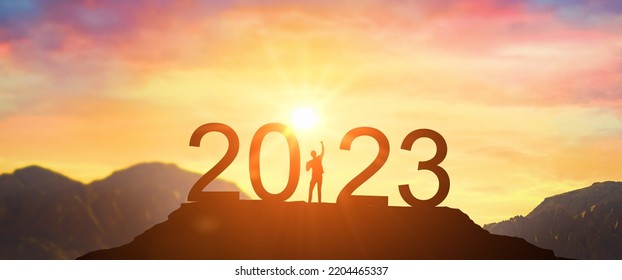 2023. New Year 2023, New Start motivation inspirational quote message. Man meets dawn in mountains for new year 2023. New Start motivation inspirational quote message on silhouette man - Powered by Shutterstock