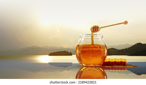 3D Honey Jar With Wooden Honey Stick Dipping Some Pure Sweet Honey Bee Organic Food Shiny Golden Brown Color On Glossy Table And Some Melt Fluid Blurred Soft Light Color Natural View Background