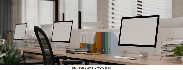 A 3D illustrated modern open plan office interior featuring blank screen monitors, colorful binders, and ergonomic chairs, ideal for business and technology mockups.