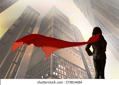 3D Illustration Of Business Woman Dressed In A Suit With A Cape Superhero On A Background The Sky On The Background Of Skyscrapers Of The City