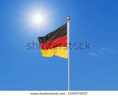 Waving German flag in front of a blue sky with clouds, Hallig Oland in the background