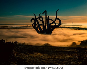 3d illustration of a giant tentacle monster rising out of a sea of fog