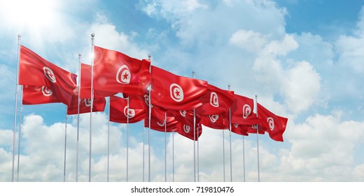 3d Illustration of many flags of Tunisia in rows waving in the wind against blue sky - Powered by Shutterstock