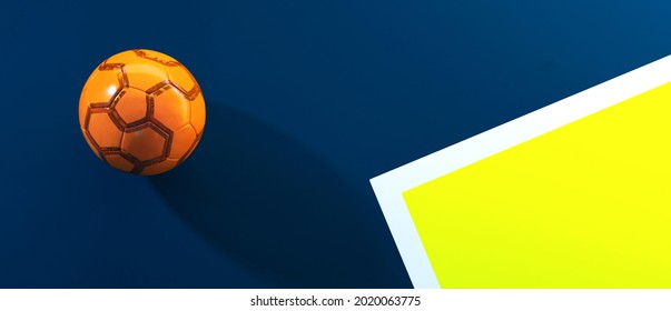 3D Illustration. Orange futsal soccer ball laying on the blue indoor soccer field background - Powered by Shutterstock