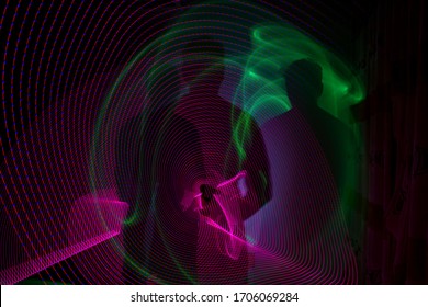 3D Illustration Or 3D Render. Abstract Image Made With Lightpainting. Colored Lights On Black Background. Human Silhoutte. Vibrant Colors In Abstract Pattern.