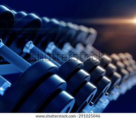 3d illustration of row of dumbells with lens flare and depth of field effect