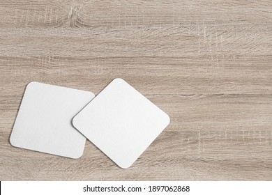 3D Illustration. Square Coaster Mockup Isolated On Wooden Background.