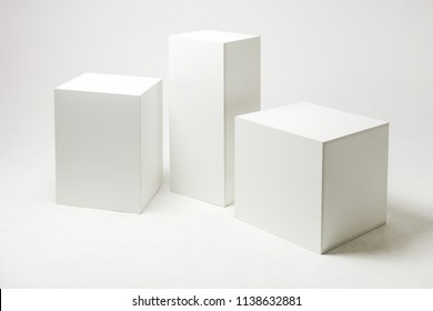 3D Illustration Of White Cubes And Parallelepipeds On Cyclorama In Modern Photo Studio