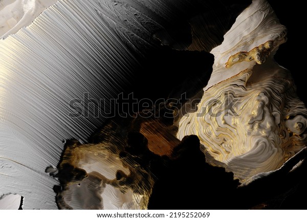 3d render of abstract art with parts of
damaged 3d ball planet earth , moon or asteroid in spherical shape
with big cracks in organic rough shape on surface with gold parts
on black background