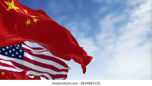 3D render of Chinese and American flags waving side by side in the wind, symbolizing diplomacy, patriotism and international relations under a clear sky.